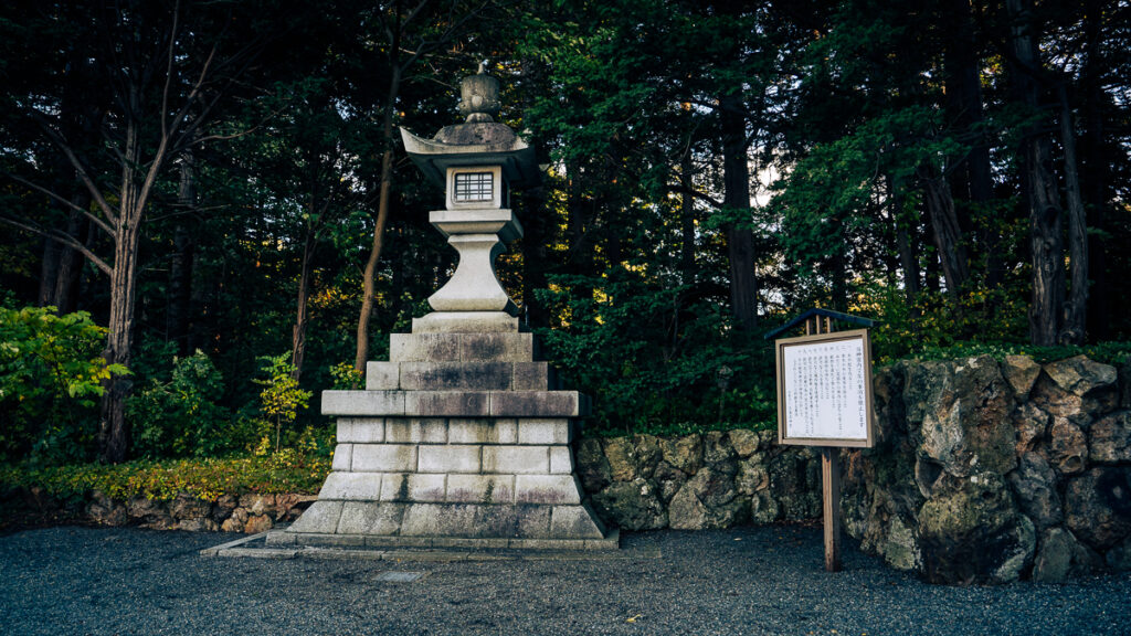 Stone lantern along the shrine path surrounded by greenery at Hokkaido-Jingu
