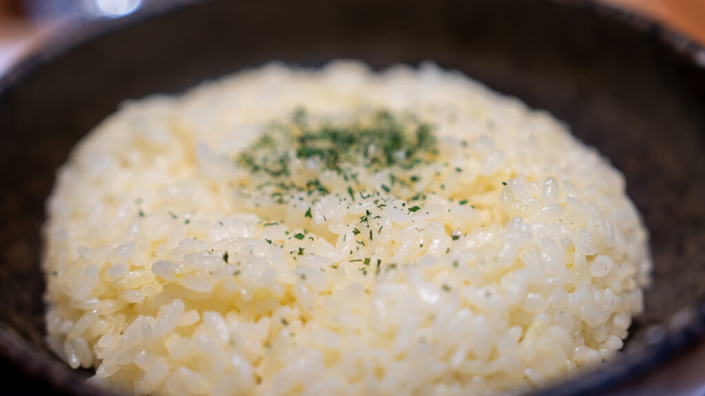Rice in a black bowl served with soup curry in Sapporo.