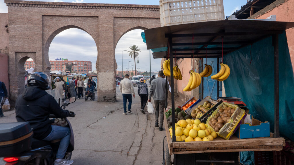 Fruit vendor working near a gate in Marrakech’s rampart walls