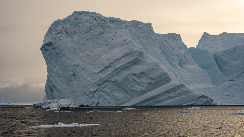 Iceberg showing diagonal bands and layers of compressed glacial ice.
