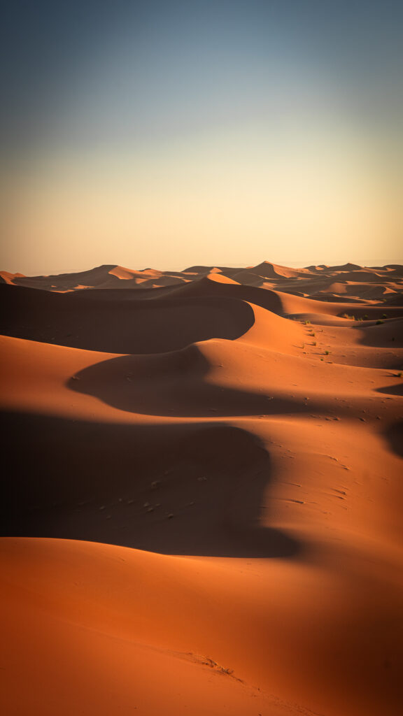 Vertical view of a dune ridgeline with strong shadows near Erg Chigaga in the Sahara Desert.