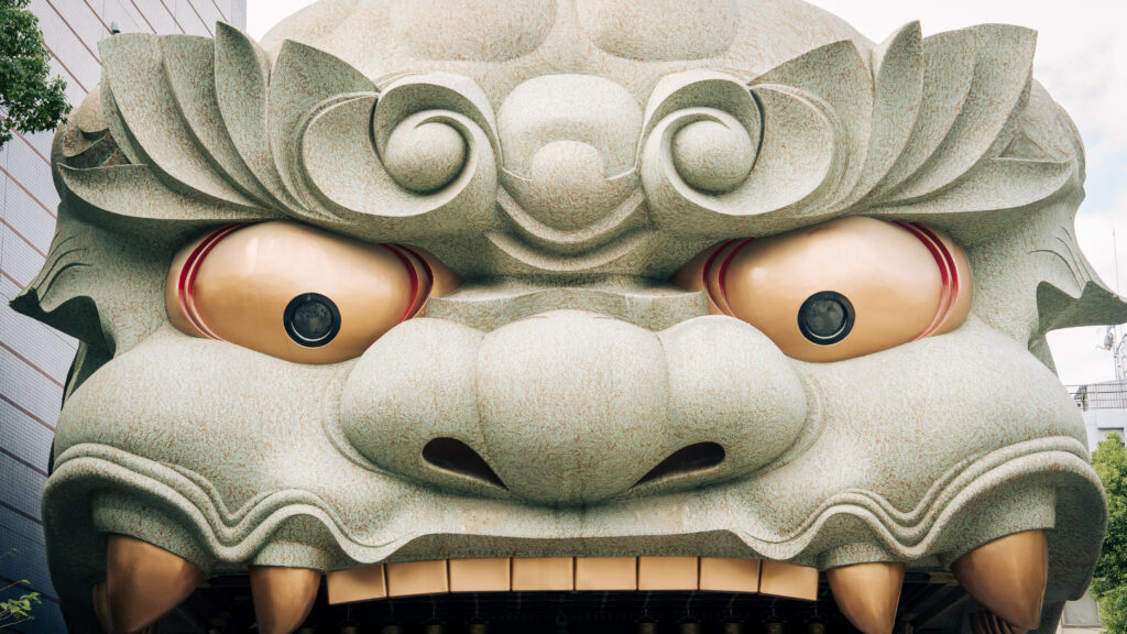 Close-up of the lion head structure at Namba Yasaka Shrine in Osaka, showing carved details and scale.