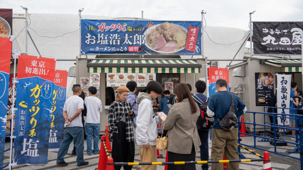 Booth advertising soup-free hearty salt ramen at Tokyo Ramen Festa.