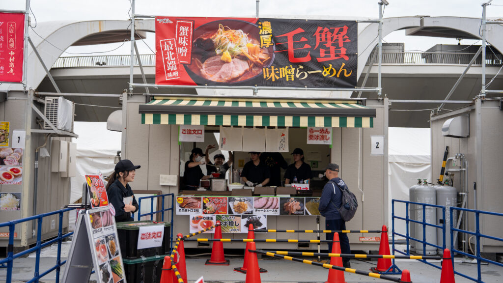 Booth advertising rich hairy crab miso ramen from Sapporo.