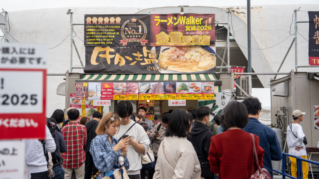 Visitors gather outside a booth serving Sendai beef tongue ramen.