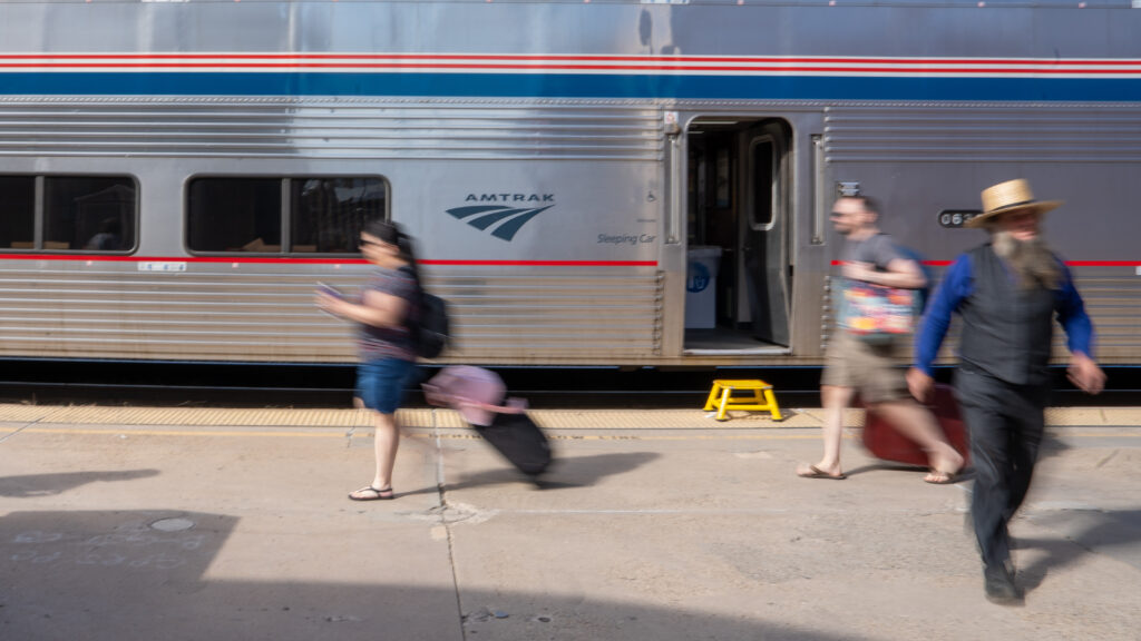 Long exposure of people walking on a Colorado train platform during a brief stop.