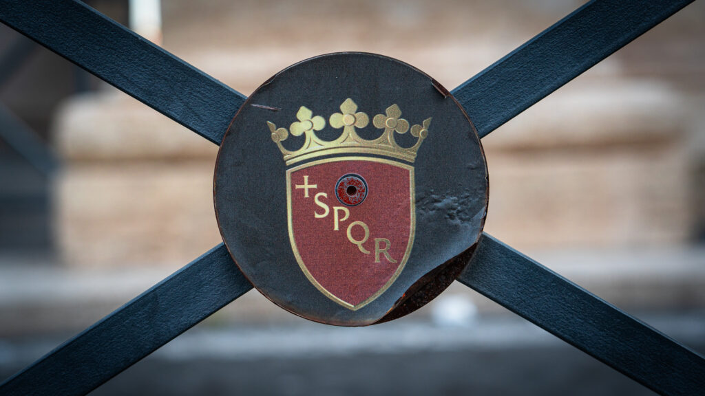 Close-up of SPQR emblem on railing outside St Peter’s Basilica in Rome